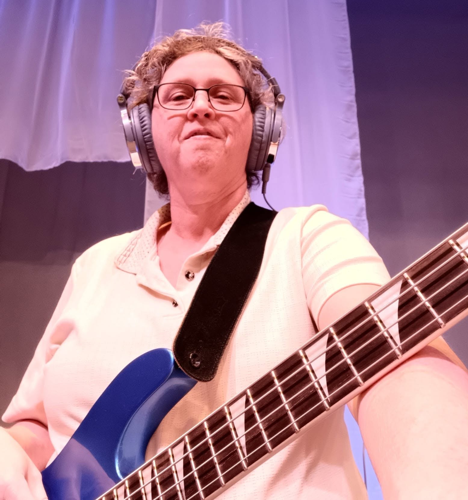 Ginger playing bass guitar on stage